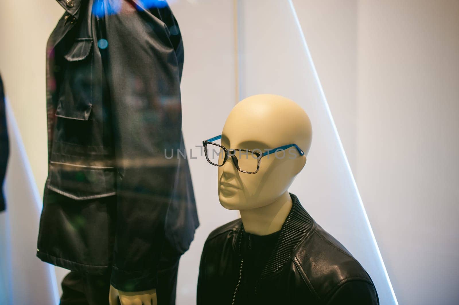 dummy on a shop window. Faceless man's glasses