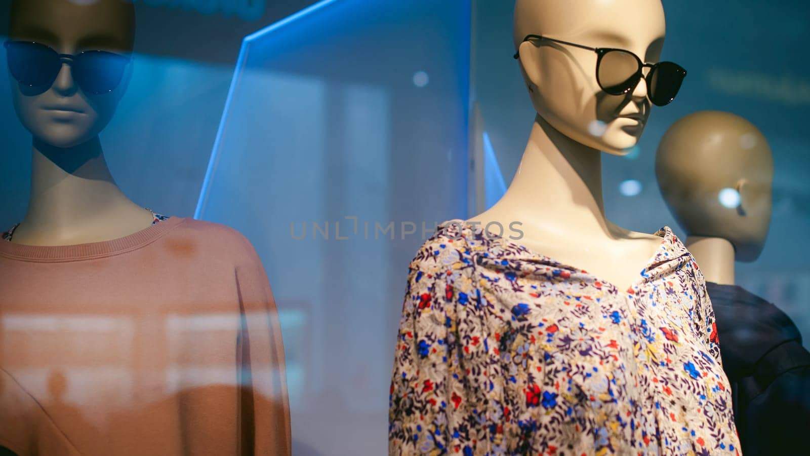 dummy on a shop window. Faceless woman with glasses