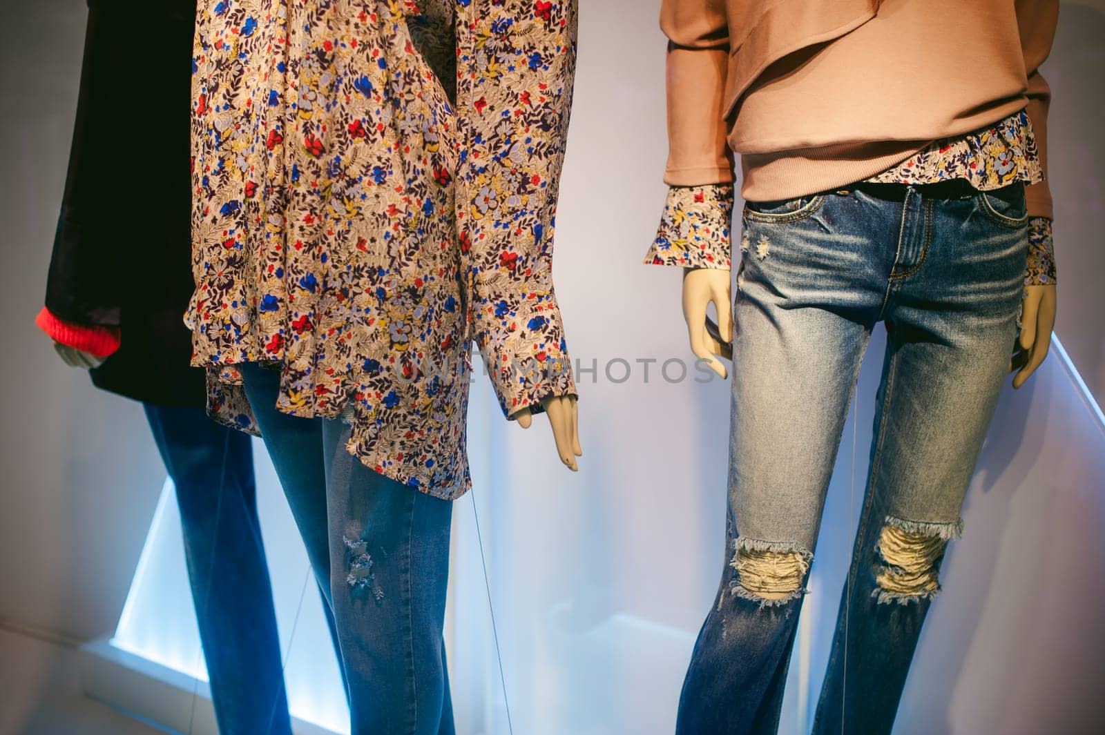 dummy on a shop window. Women's hands and feet in fashionable clothes