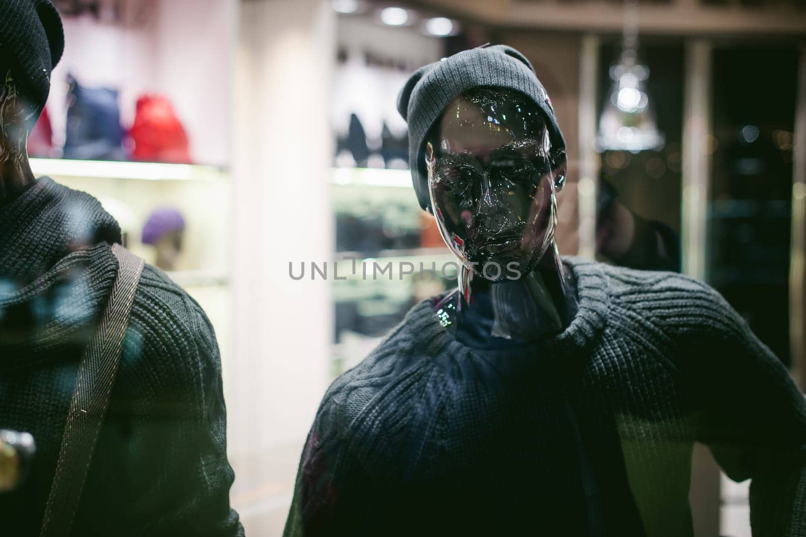 dummy on a shop window. Faceless black man in hat