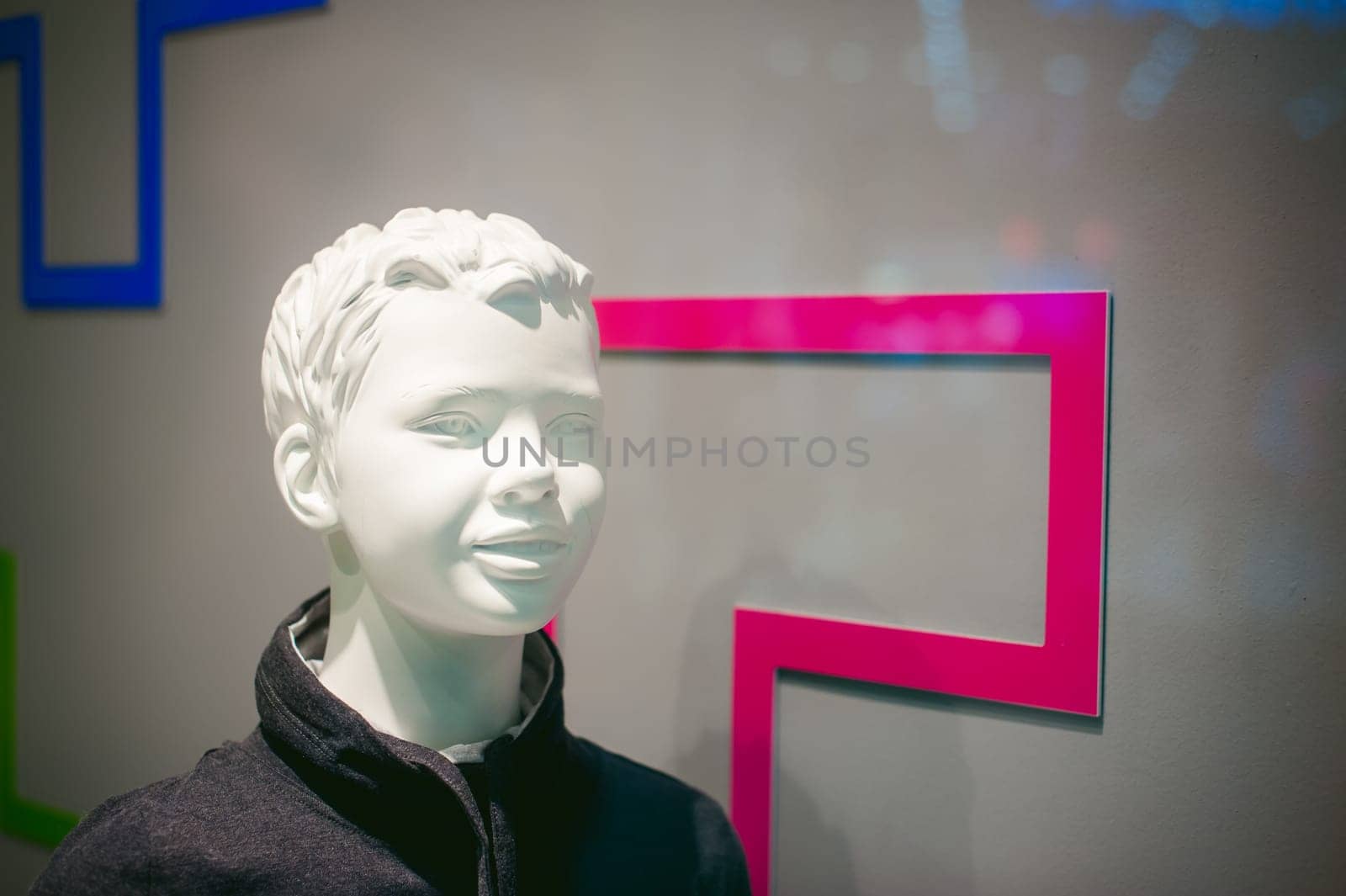 dummy on a shop window. Child face in the background of the store