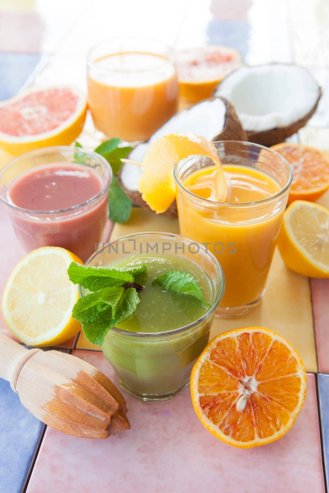 Various colorful smoothies and fresh fruits