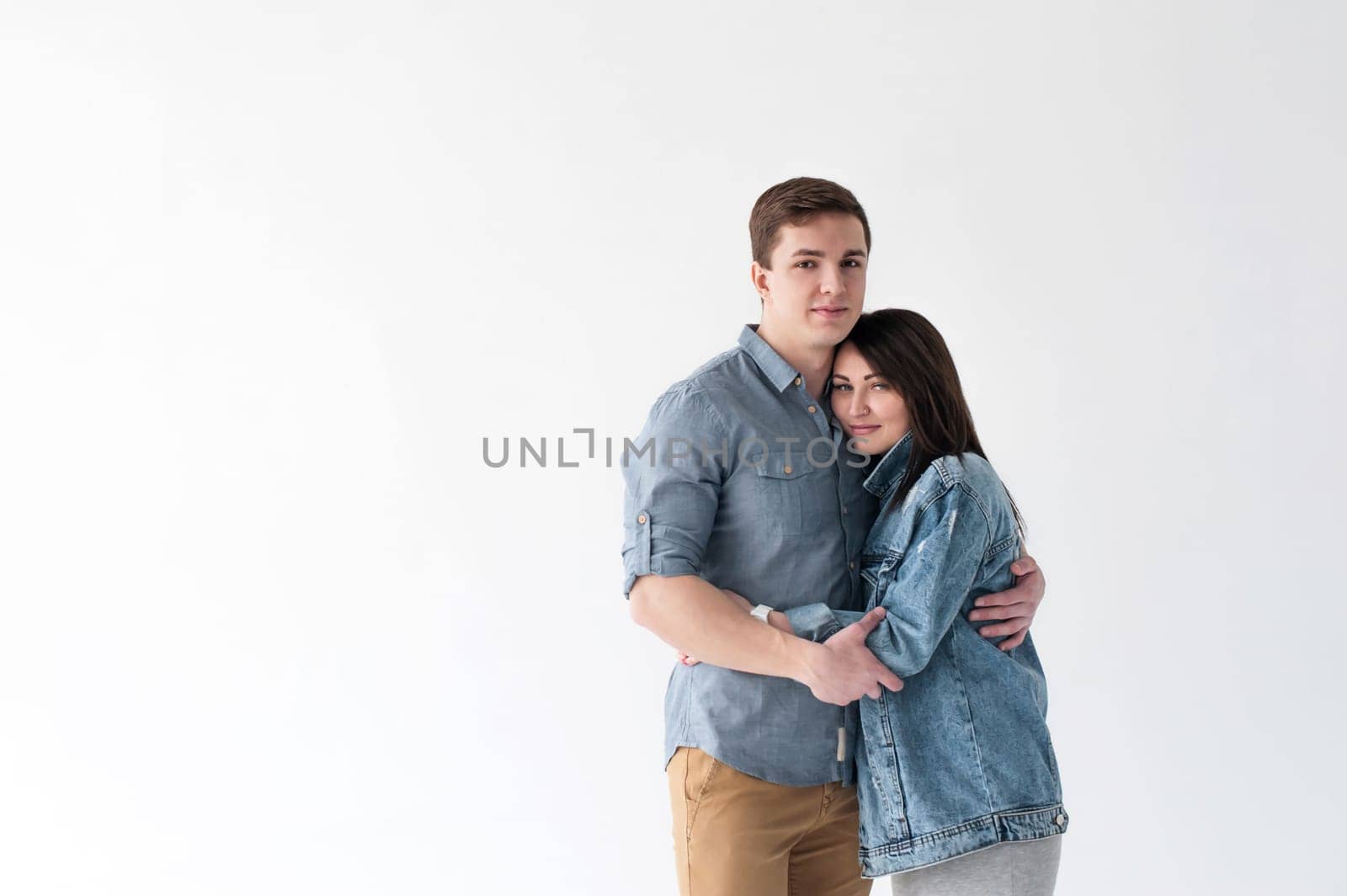 young couple, man and woman in trendy jeans clothes, studio shot on white background