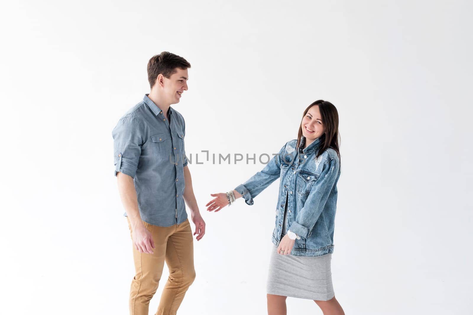 young couple, man and woman in trendy jeans clothes, studio shot on white background