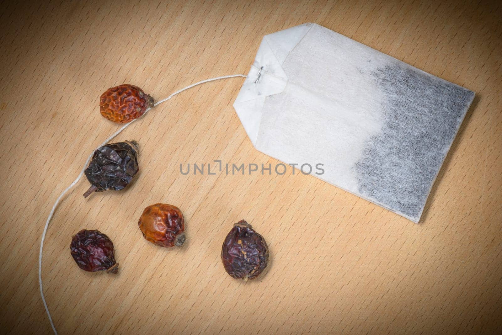 Dry Rosehip fruit for healty tisane and pocket tea on wood