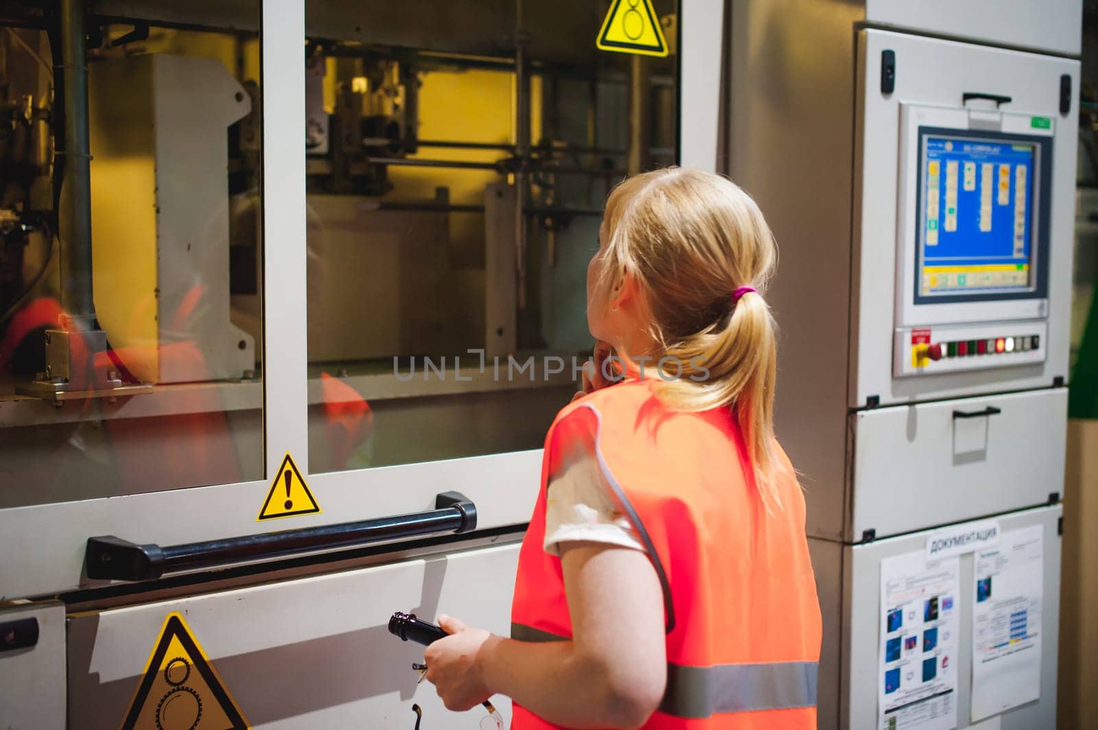 Female worker on beer factory. portrait woman in robe, standing on background line Food production, Inspection management control Equipment for production and bottling finish product end-user buyer