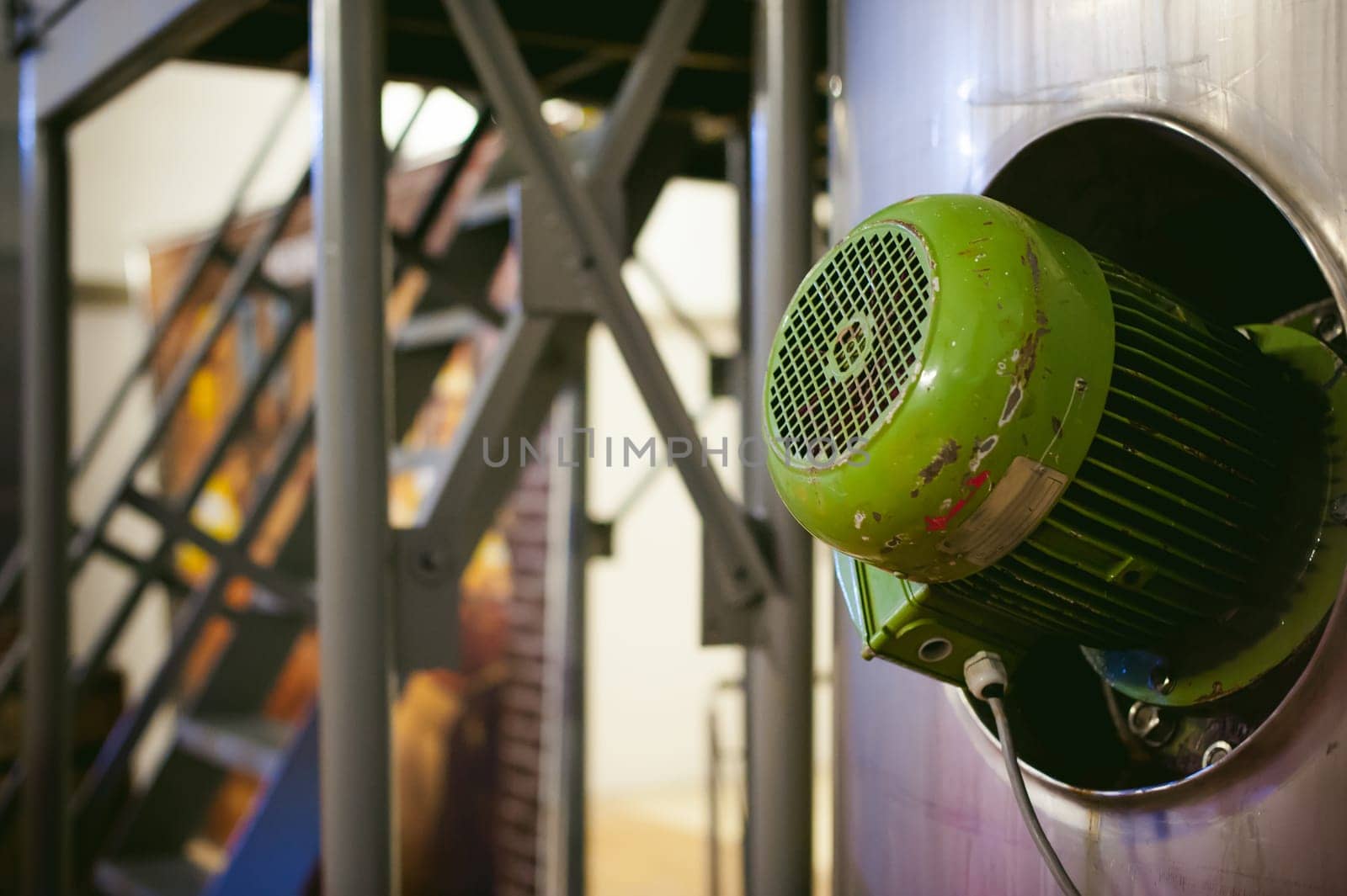 Beer manufacture line. Equipment for staged production bottling of Finished food products. Metal structures, pipes and tanks at enterprise factory. Special equipment inside within industrial premises