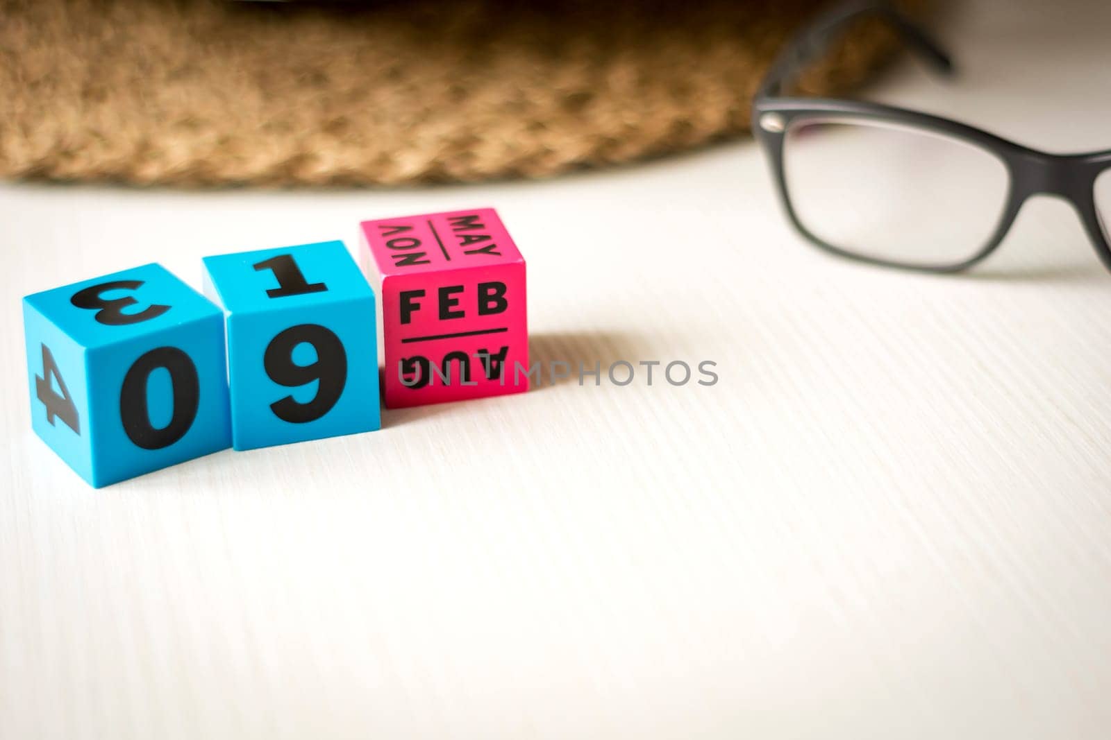 modern perpetual calendar composed of colored cubes and set at the date of February 9th