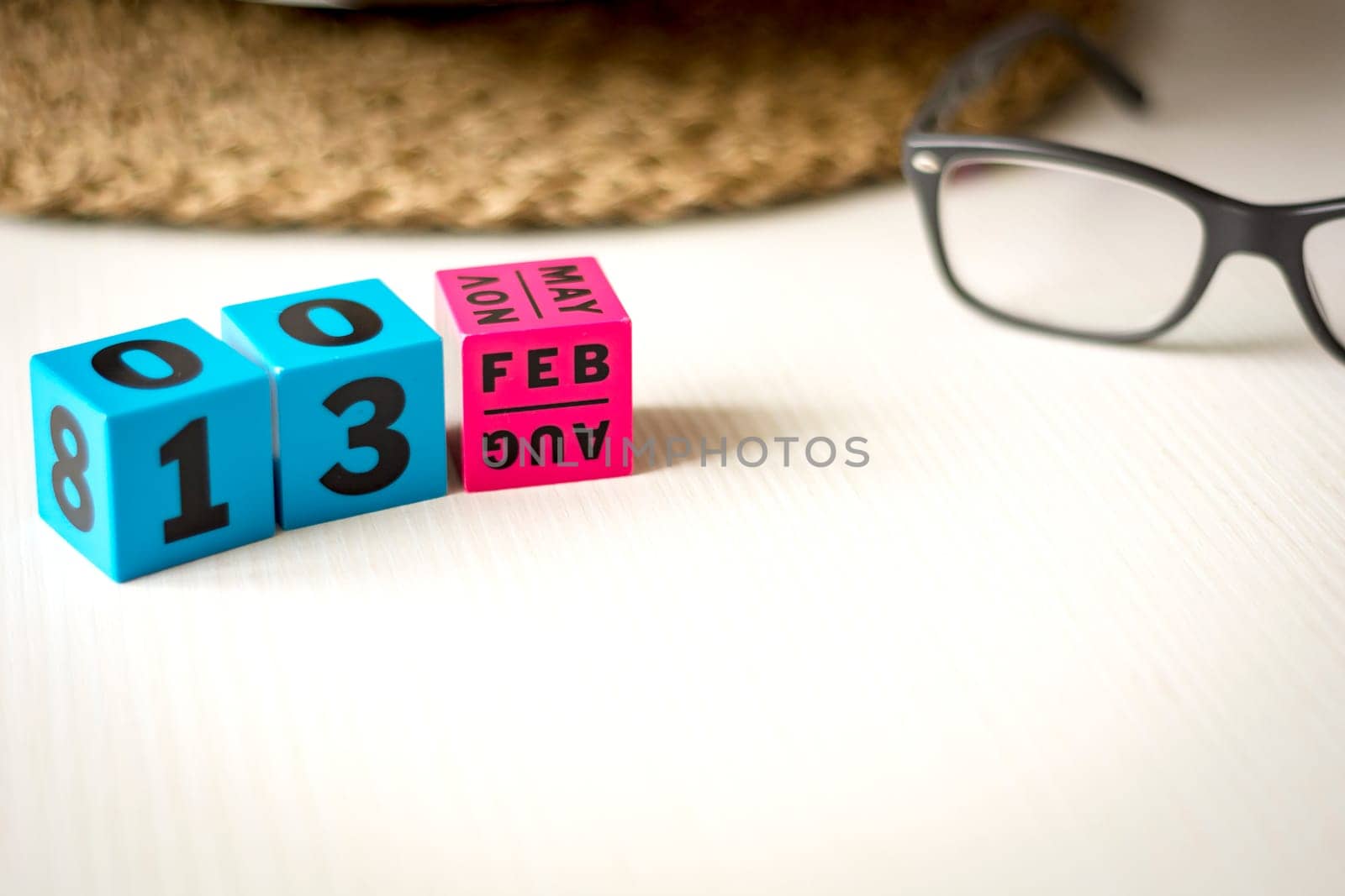 modern perpetual calendar composed of colored cubes and set at the date of February 13th