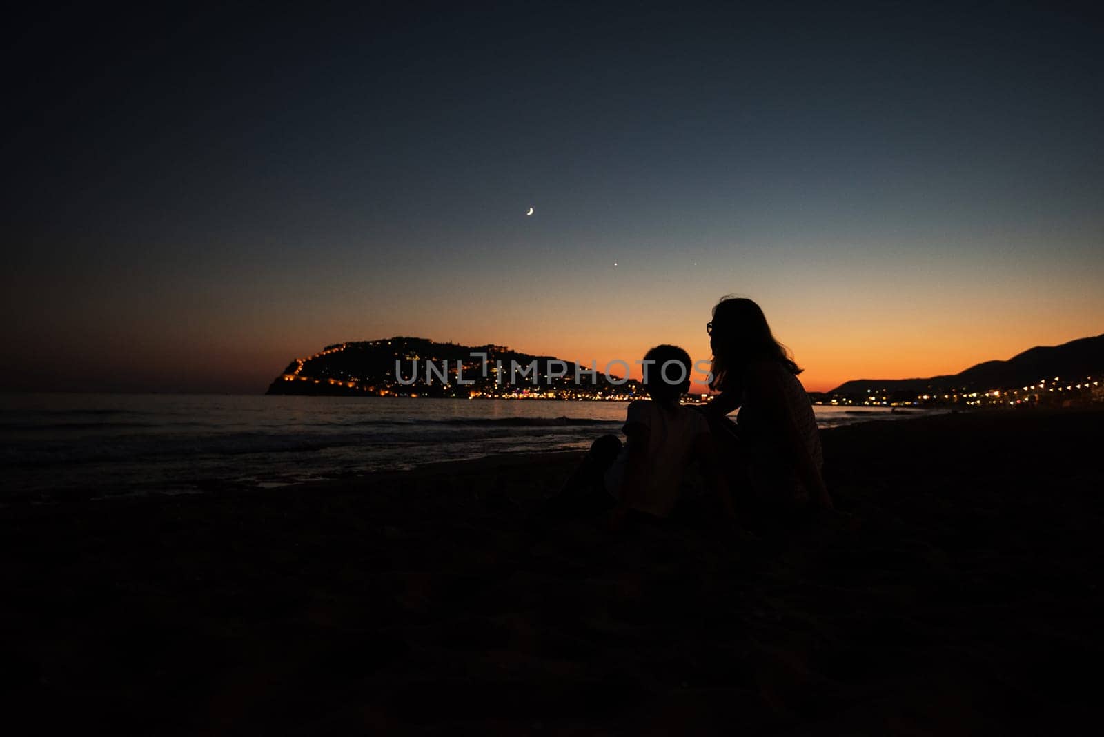 mother and son on the pier in the evening at Alania, Turkey