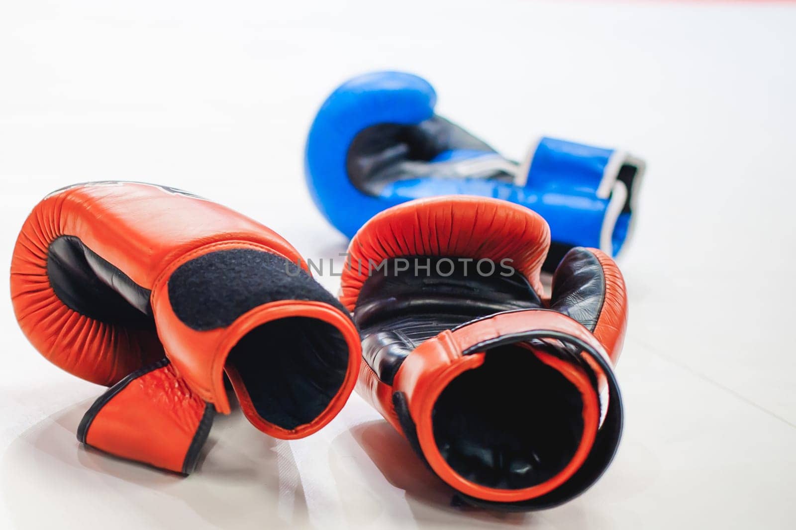 Boxing red and blue gloves Lie on white floor of ring