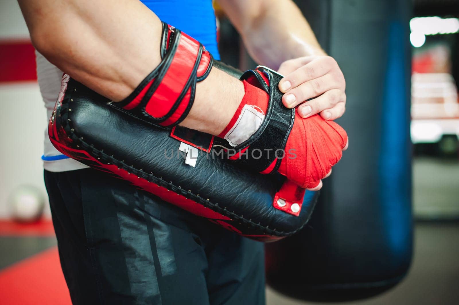Professional fighter coach puts on boxing paws