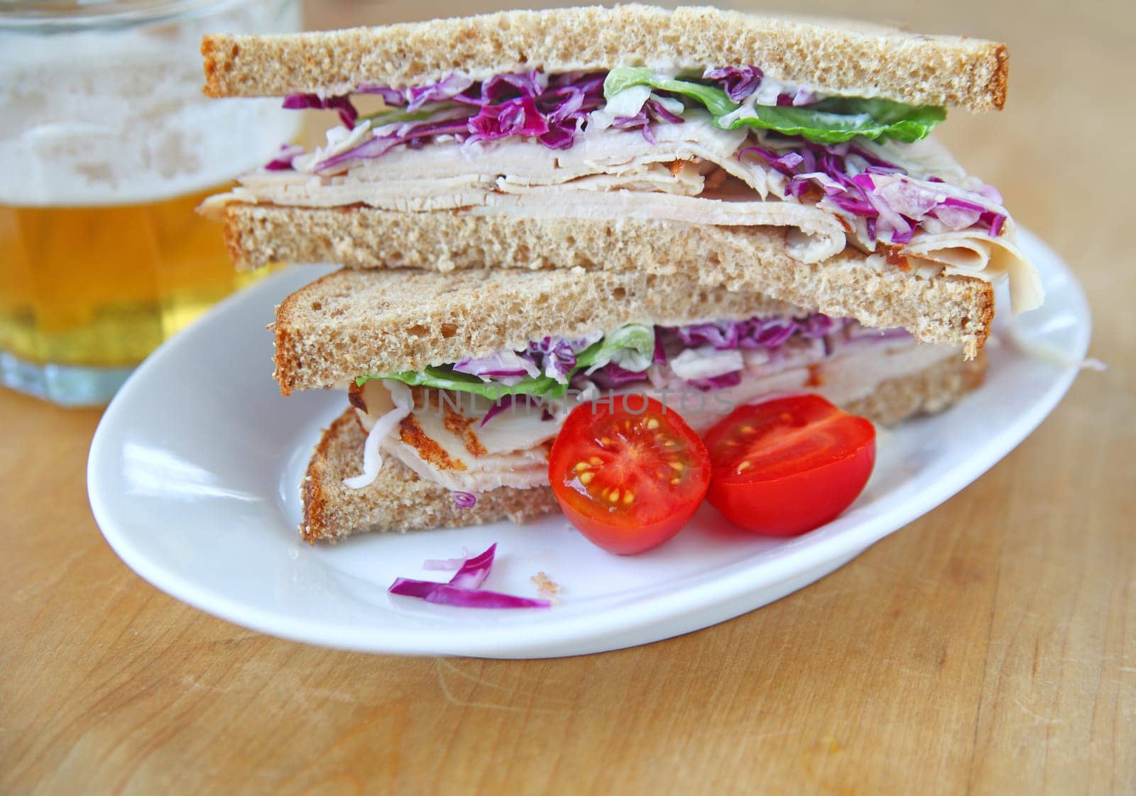 Turkey sandwich on whole wheat bread cut in half