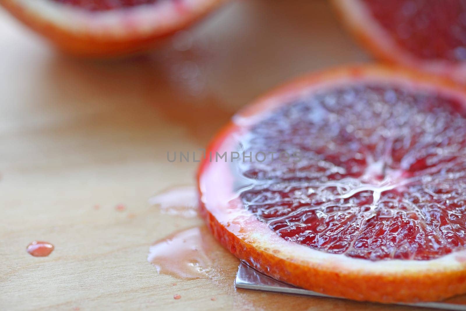 Closeup of a fresh slice of blood orange on a cutting board