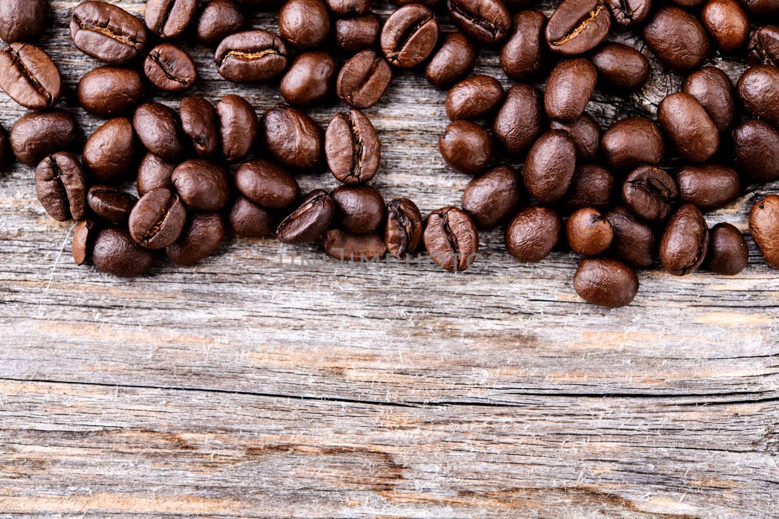 brown roasted coffee beans on wooden ground