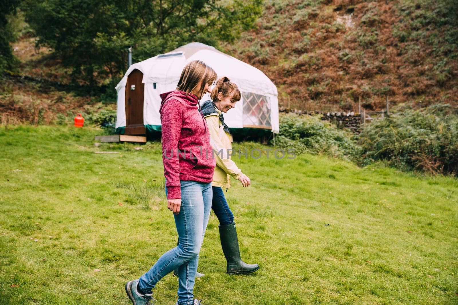 Mature woman is leaving the campsite with her mother to go for a relaxing walk.