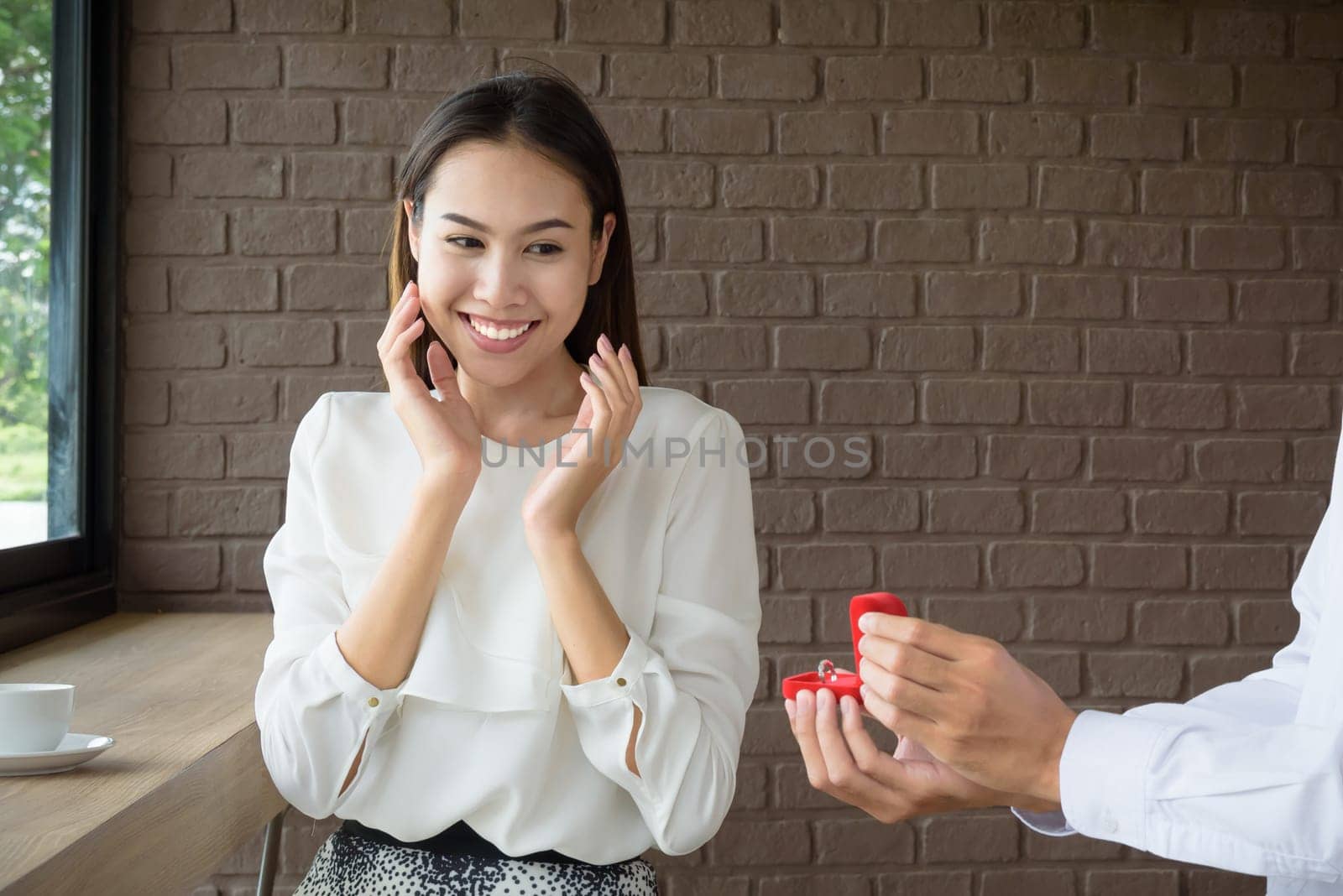 Man holding wedding ring to surprise woman, love and valentine concept