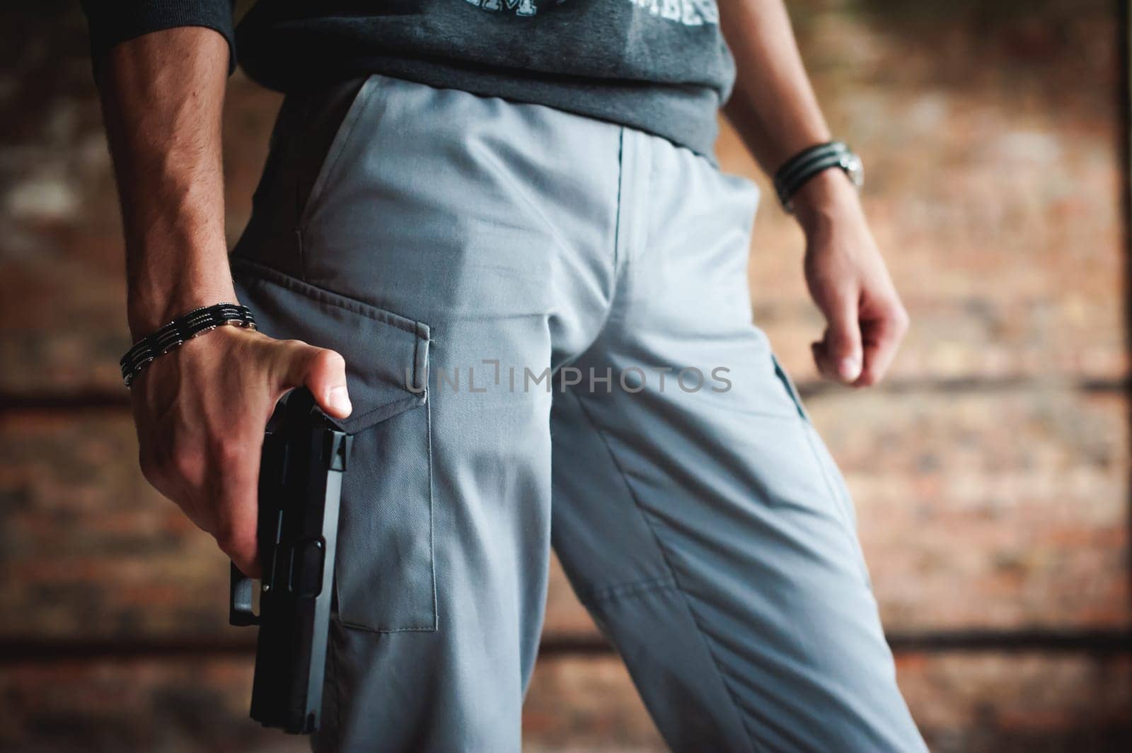 athletic man holding a gun in his hand on the ready