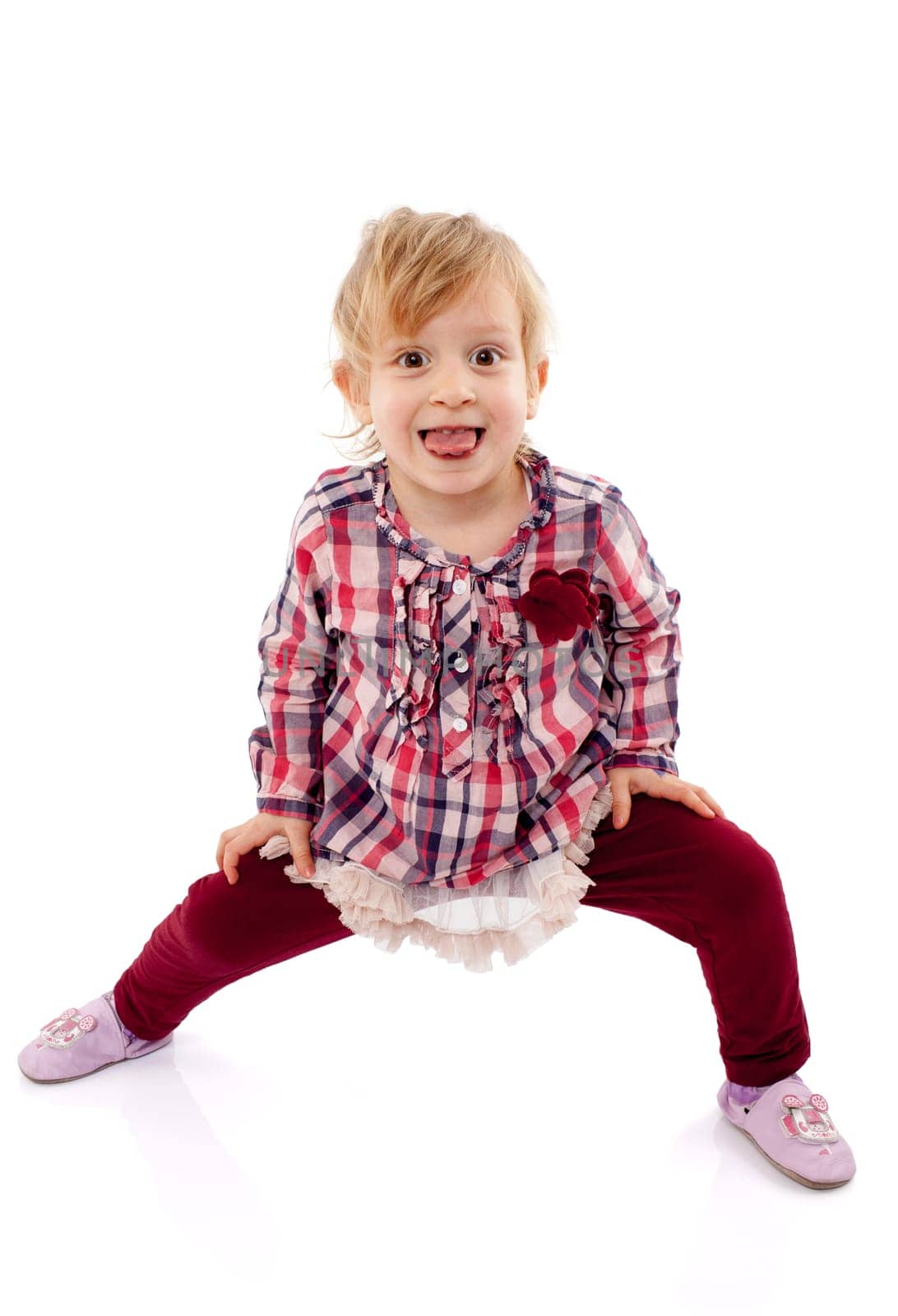 Little girl playing and having fun showing her tongue