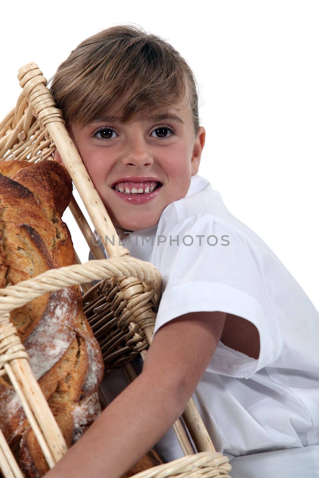 a little girl hugging a wickerwork bread bin full of bread
