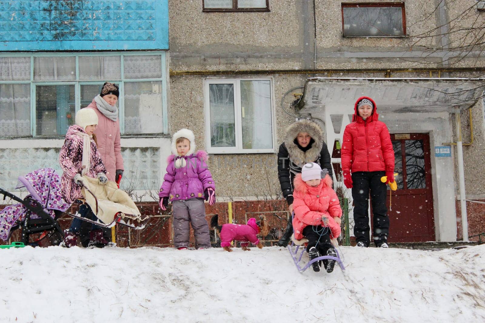 town and joy children are sleding from the hill