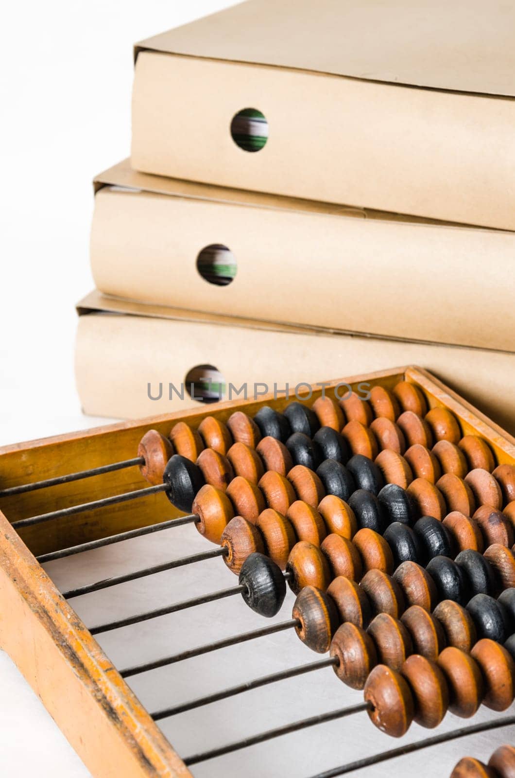 Old abacus and folders with documents, close-up