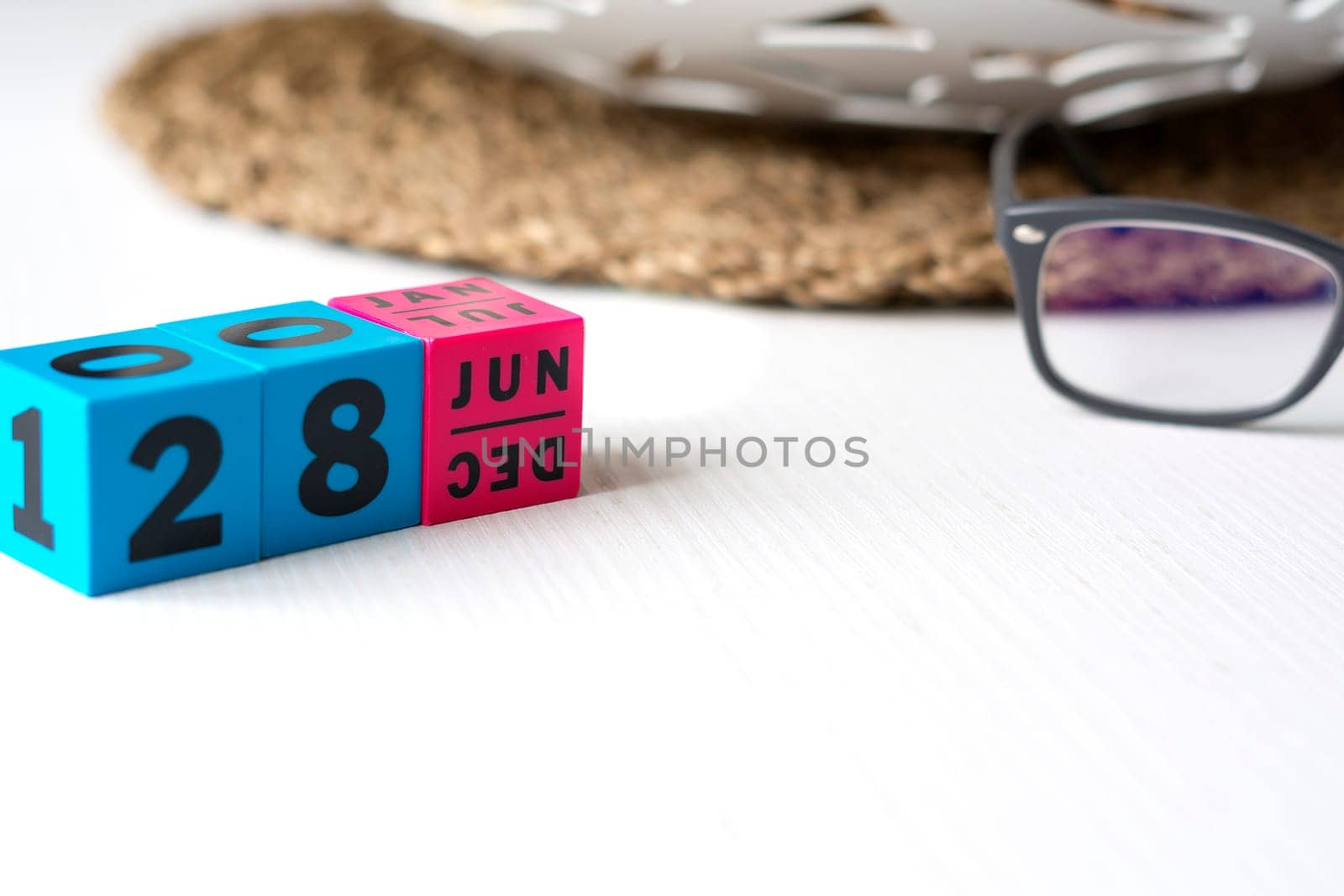 modern perpetual calendar composed of colored cubes and set at the date of June 28