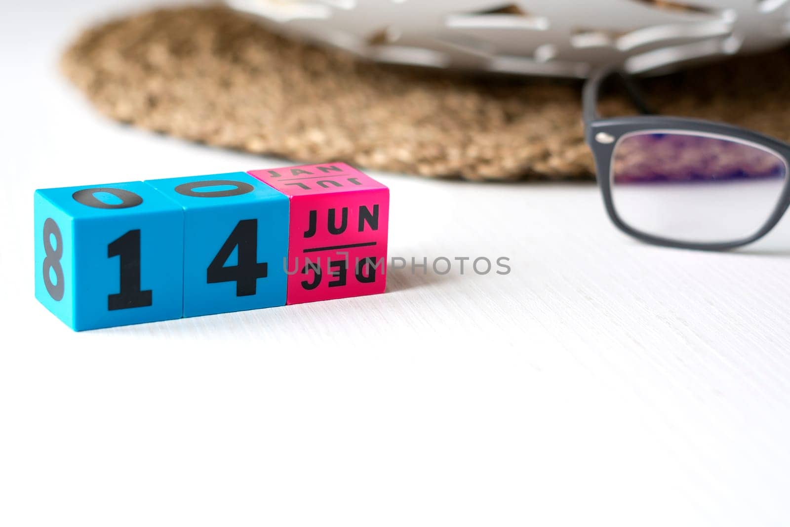 modern perpetual calendar composed of colored cubes and set at the date of June 14