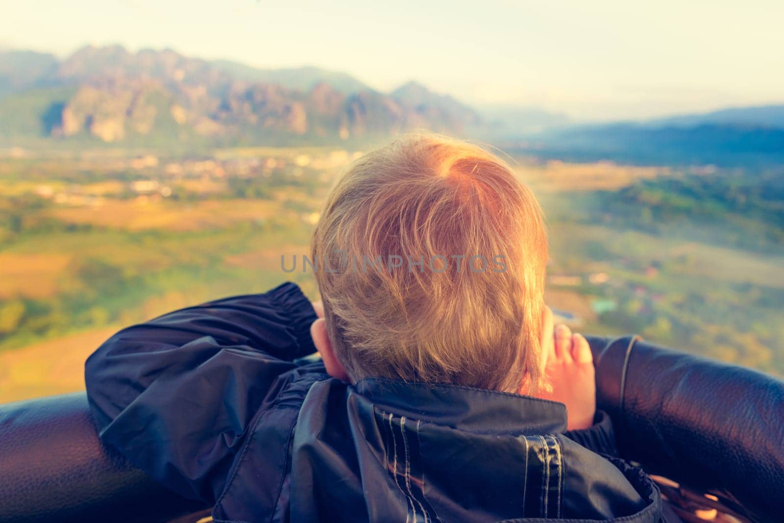Boy looking from air balloon during flight. Laos. Vang Vieng. Laos.