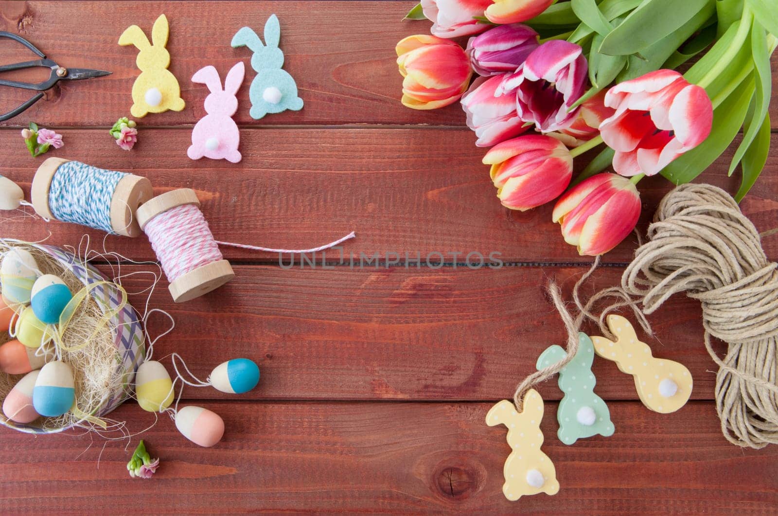 Colorful Easter decoration and tulips rustic background made of wood