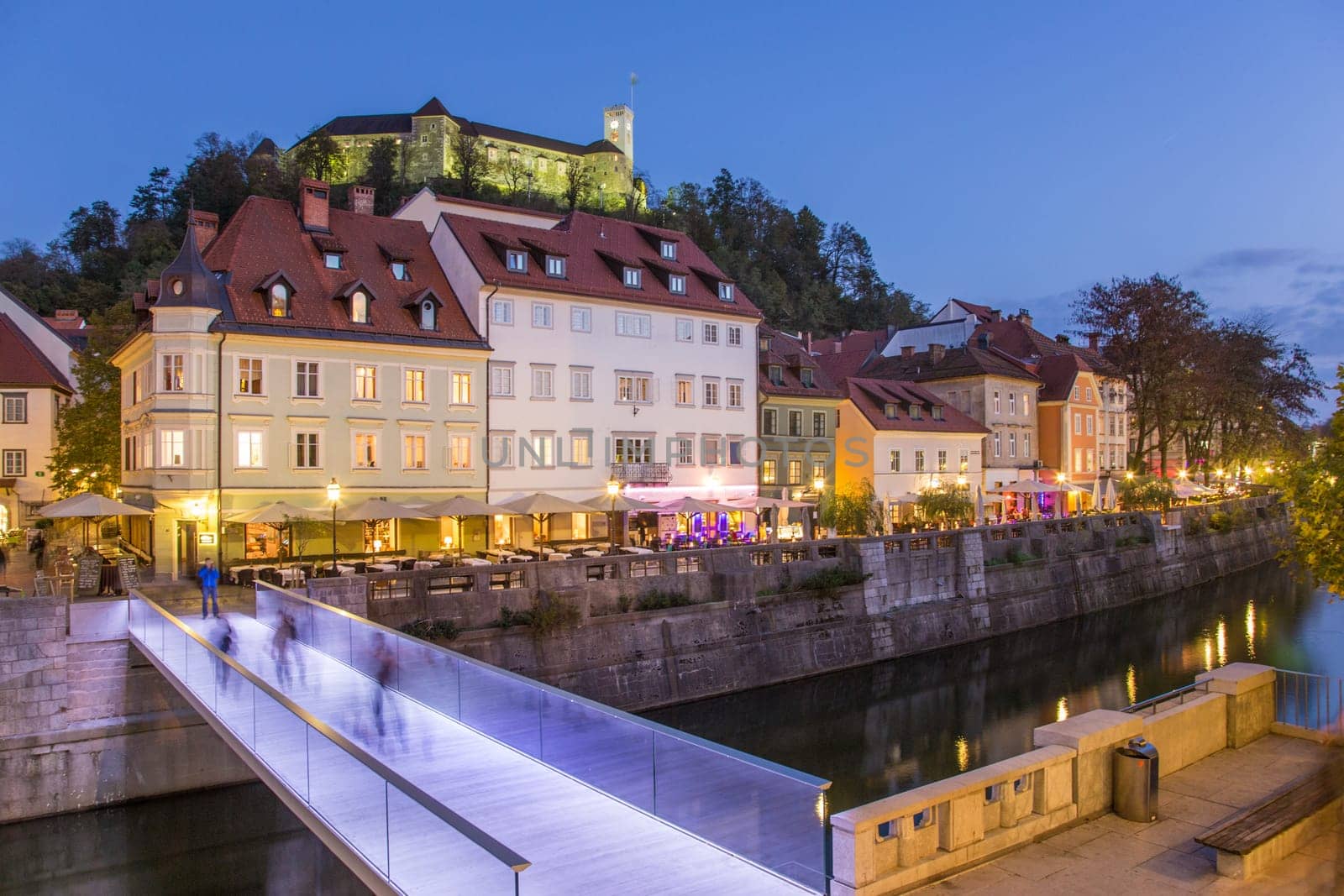 Evening panorama of Ljubljana riverfront, architecture and castle, capital of Slovenia.