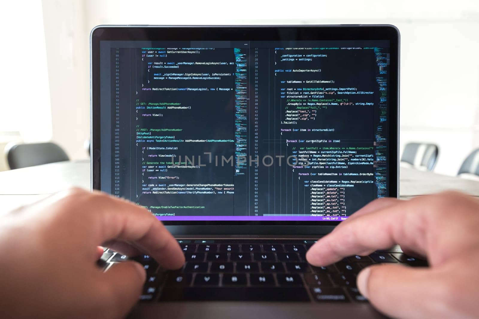 Programmer profession - man writing programming code on laptop computer. Code on screen is my property and can be seen as part of this photo.