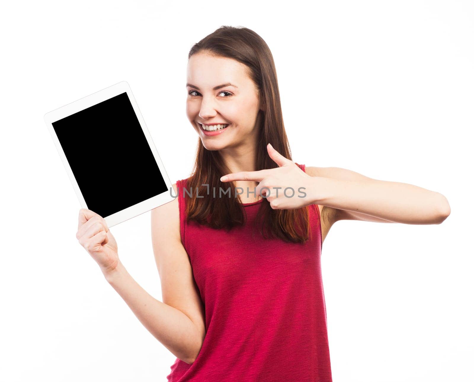 Joyful woman holding and showing the blank screen of an electronic tablet, isolated on white