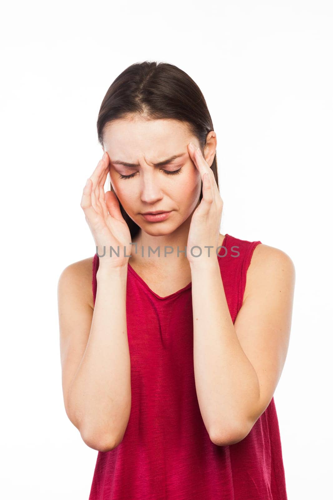 Portrait of a girl having a headache or looking stressed, isolated on white