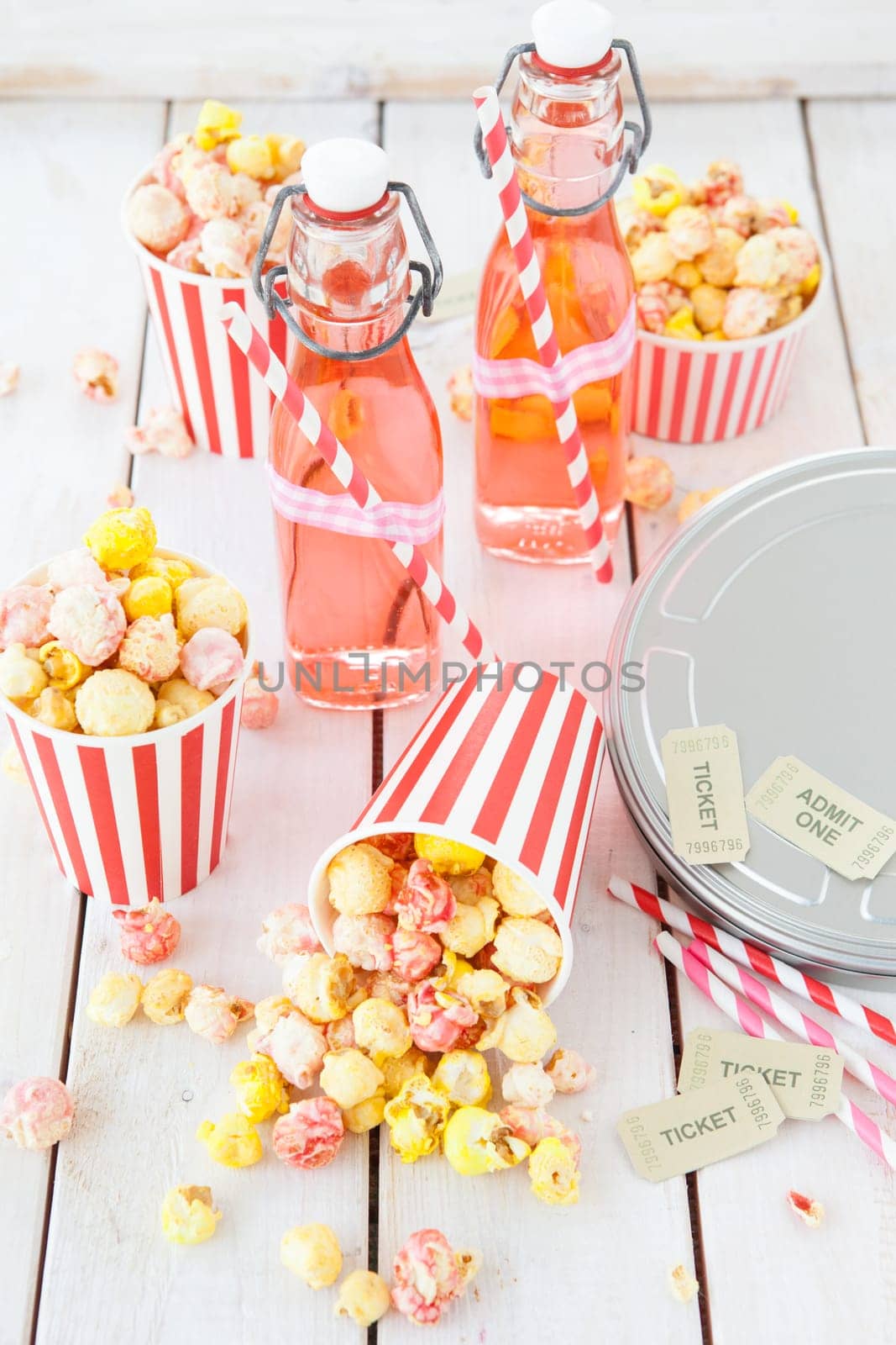 Colorful popcorn in striped cups and lemonade in small faschen