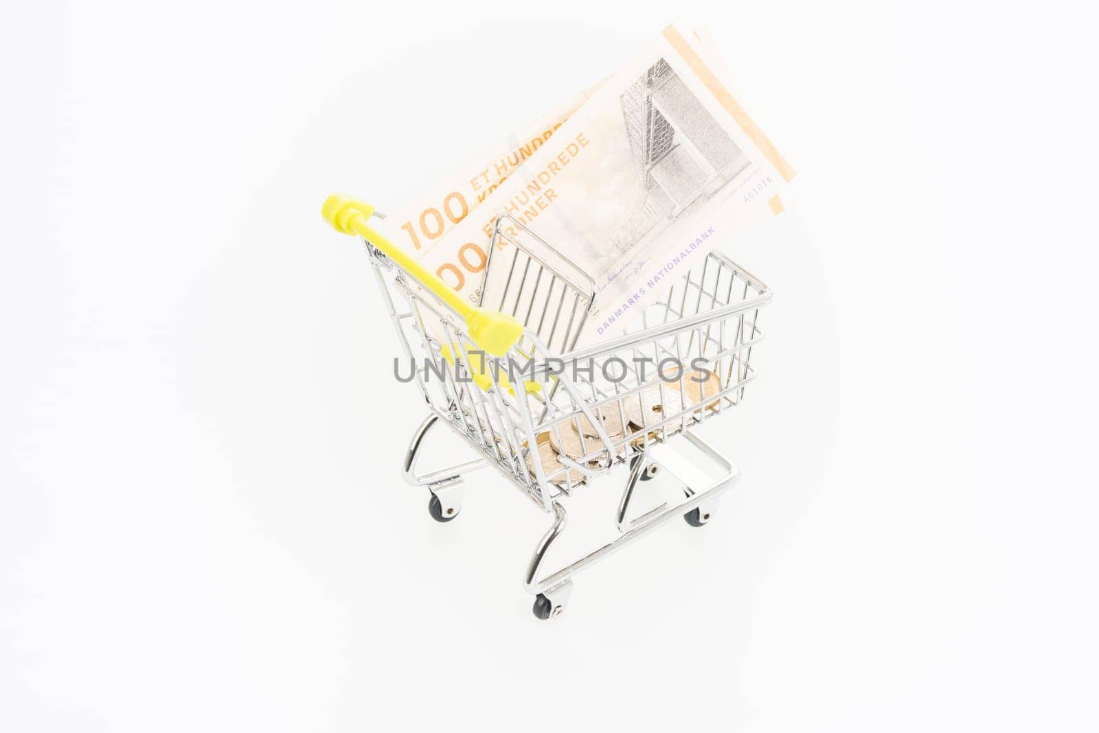 Miniature shopping cart with Danish Krone banknotes and coins