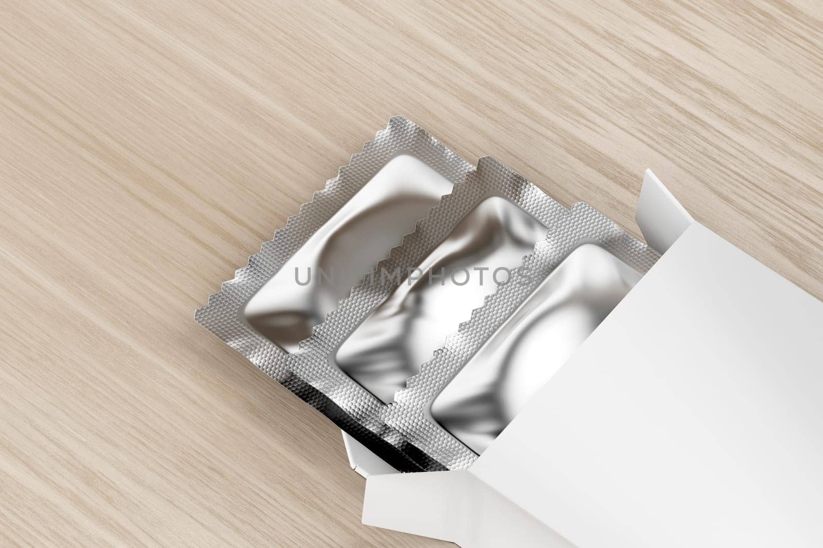 White box with three condoms inside on wooden table