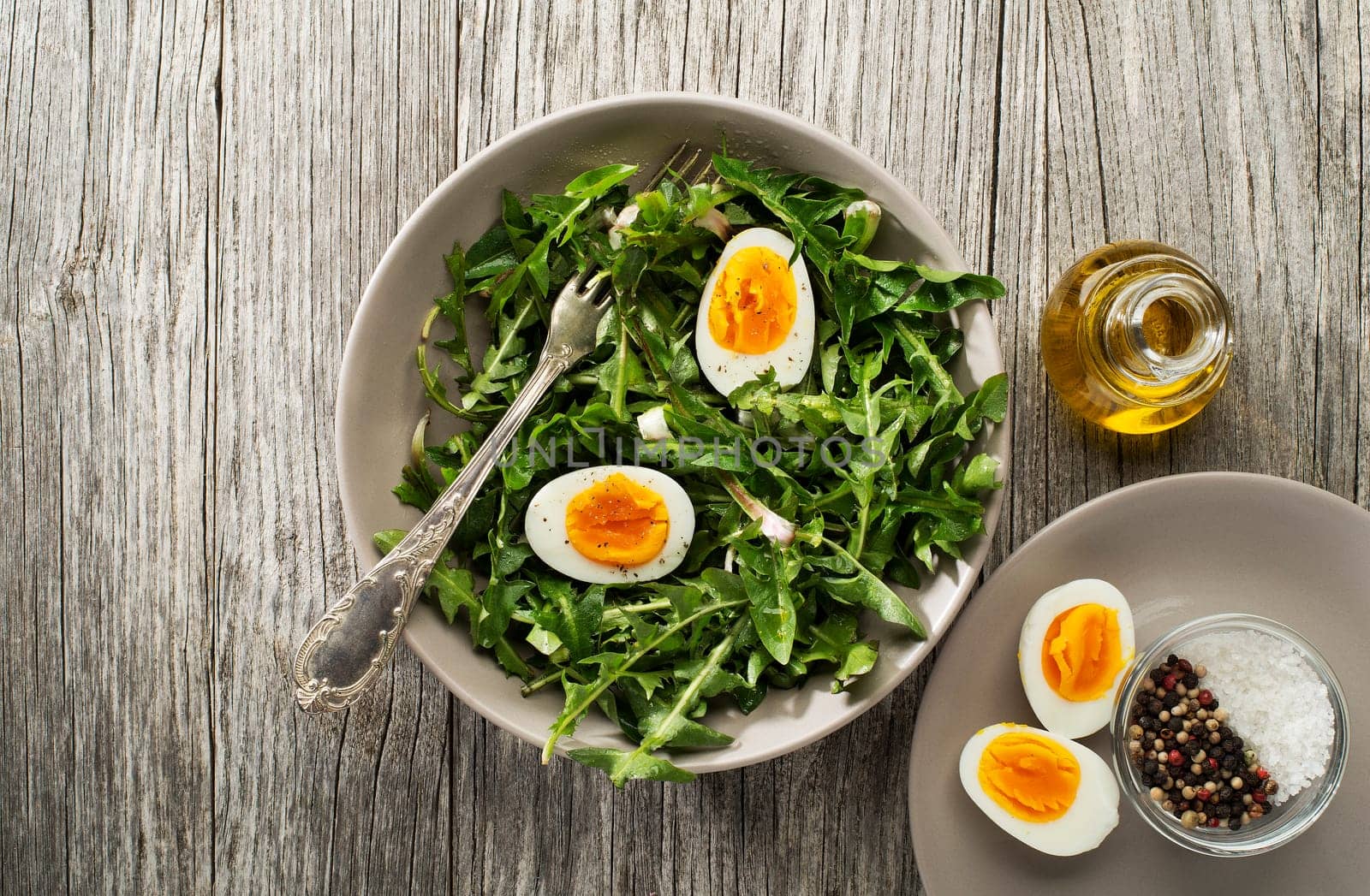 Fresh healthy dandelion salad with eggs overhead shoot