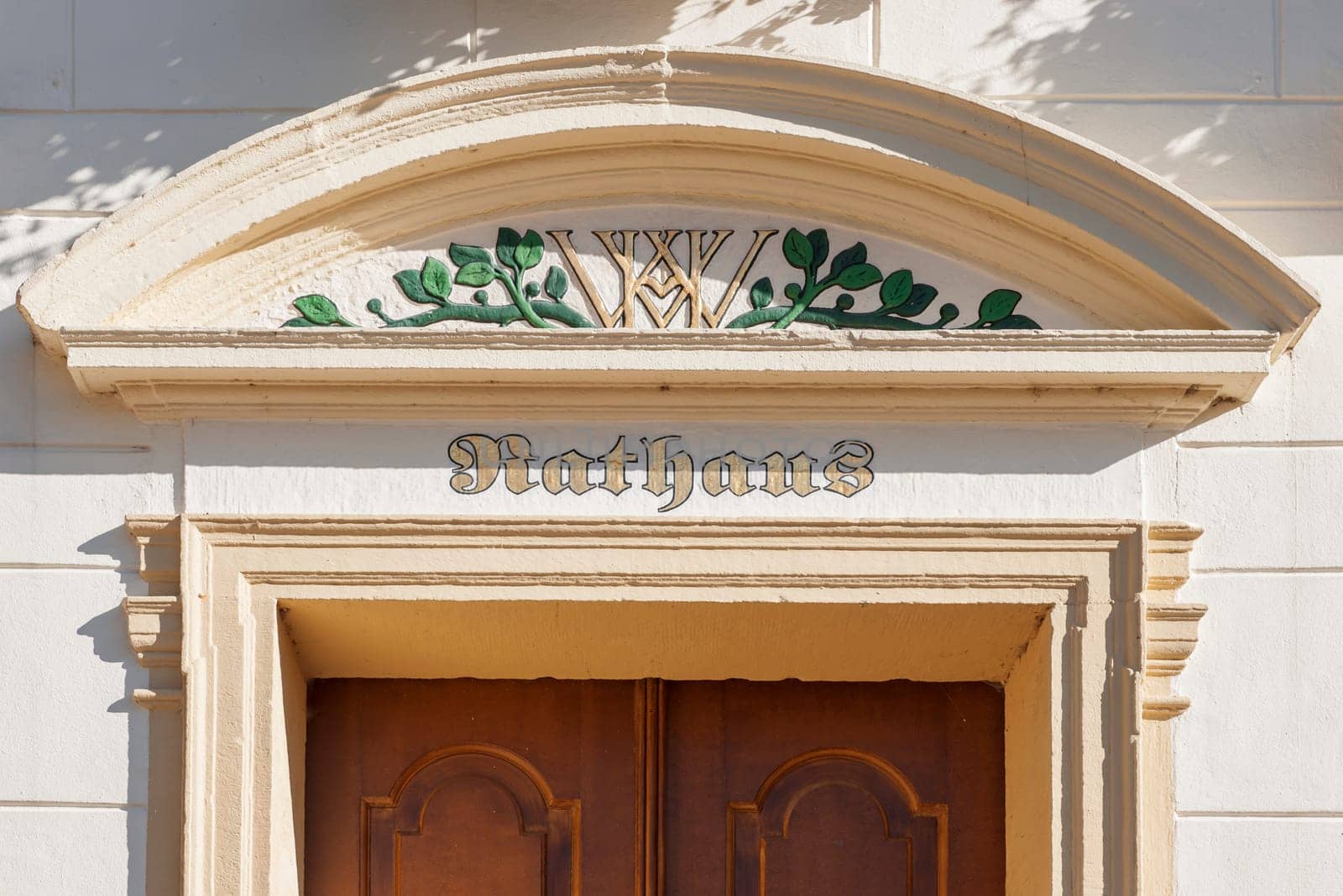 Esens,Germany - October 05,2016: Detailed view of the cornice above the door of the town hall in Esens with picture knitting and the initials chancellery director of the County of Oldenburg Wilhelm von Heespen from the 17th century.