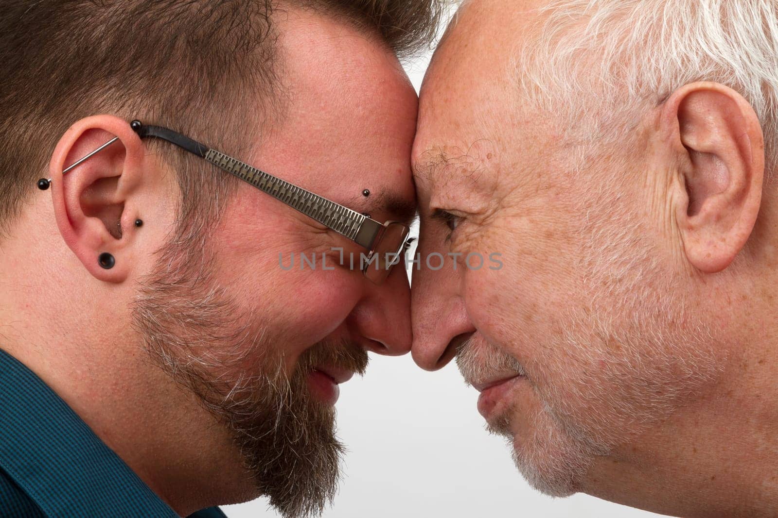 Happy gay couple with a large age difference on a bright background