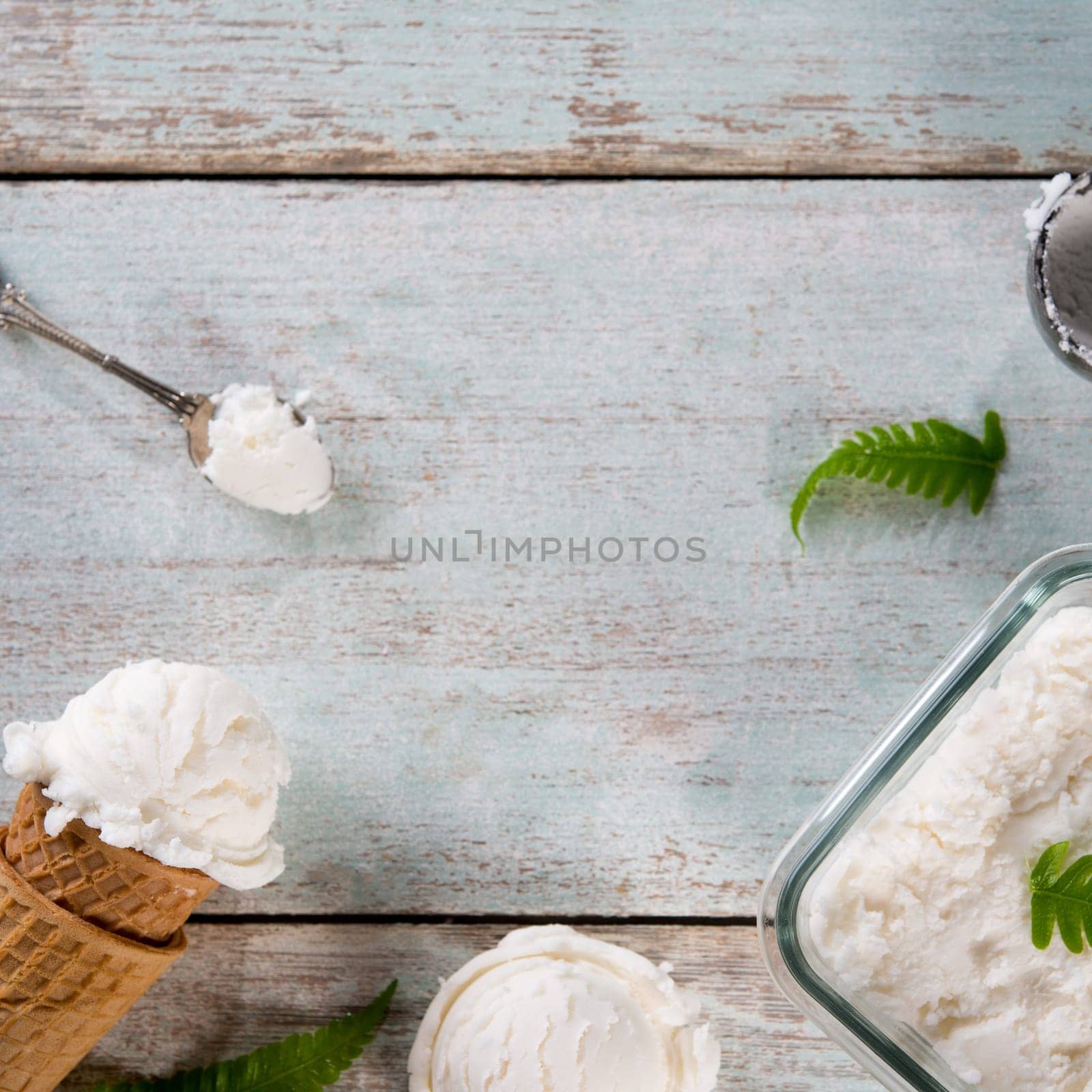 Top view coconut ice cream wafer cone on white rustic wooden background. Copy space in middle.