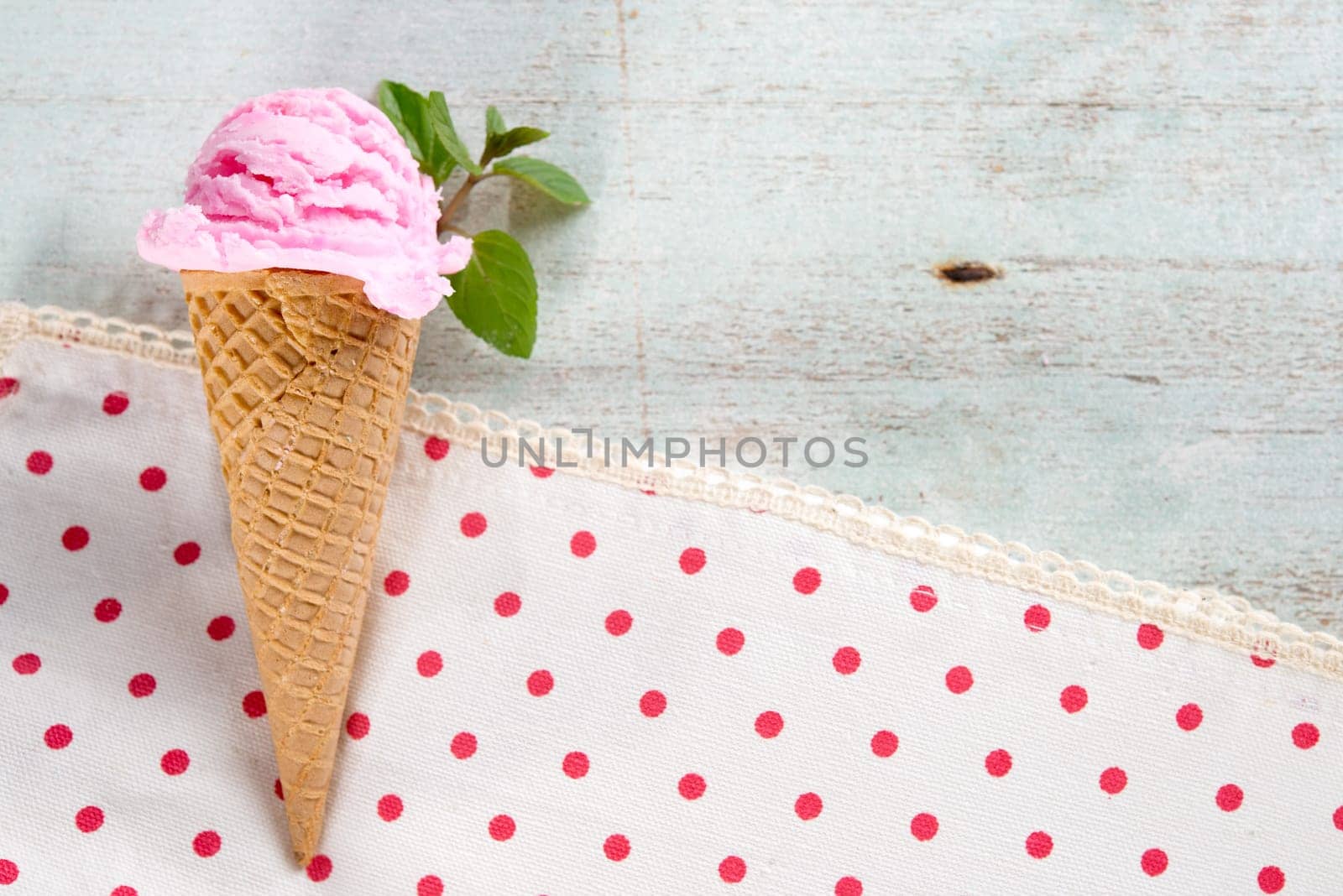 Top view strawberry ice cream waffle cone, copy space on side.