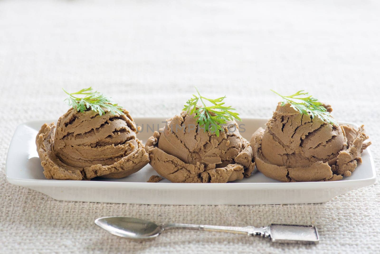 Plate of chocolate ice cream on dining table with copy space.