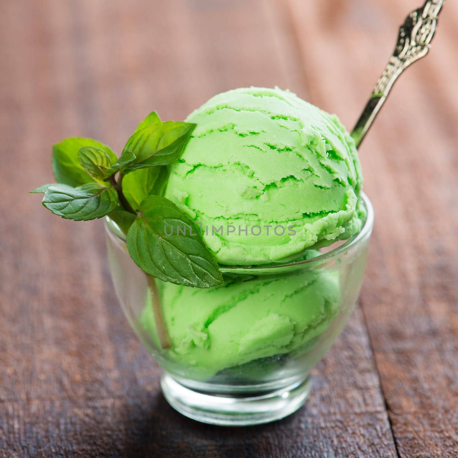 Honeydew ice cream in cup on dining table.