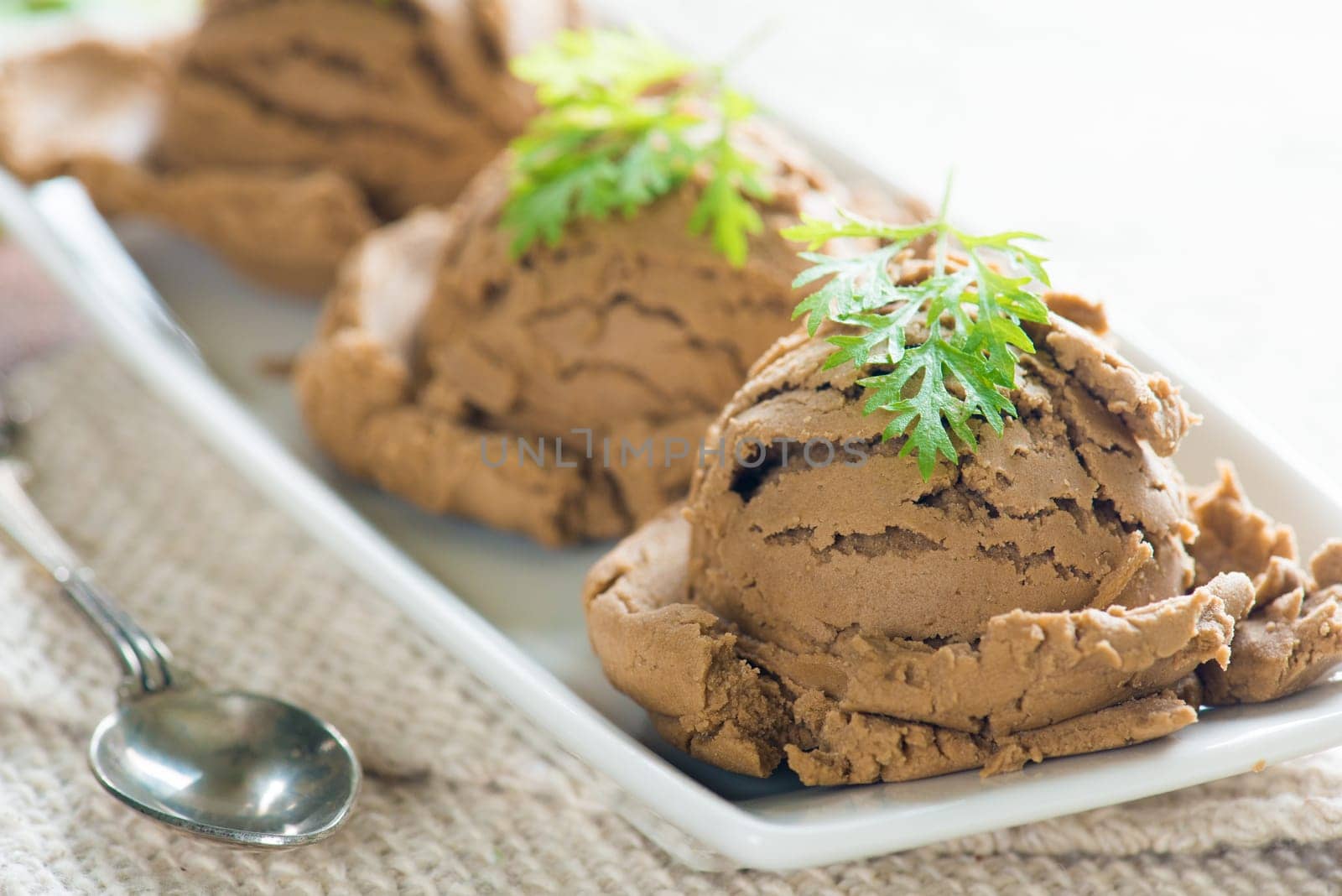 Chocolate ice cream in plate on dining table background.