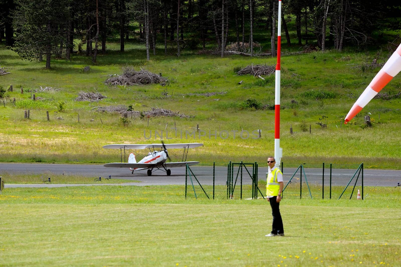 landing a biplane rolling on the Mende airfield in the French department of Gard to go to park in the place reserved for him