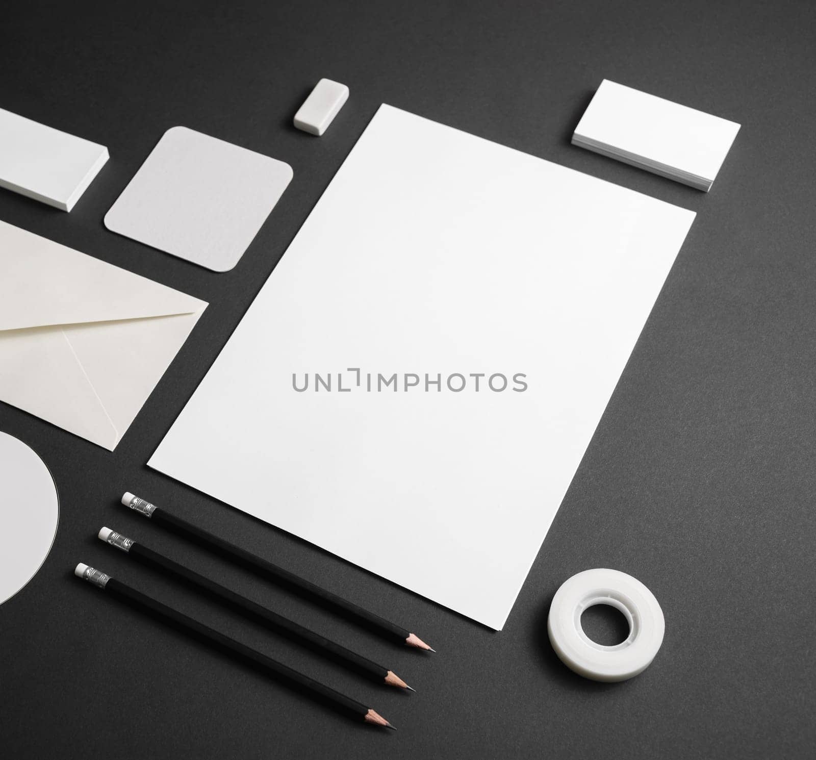 Photo of blank corporate identity template. Business stationery mock-up on black paper background.
