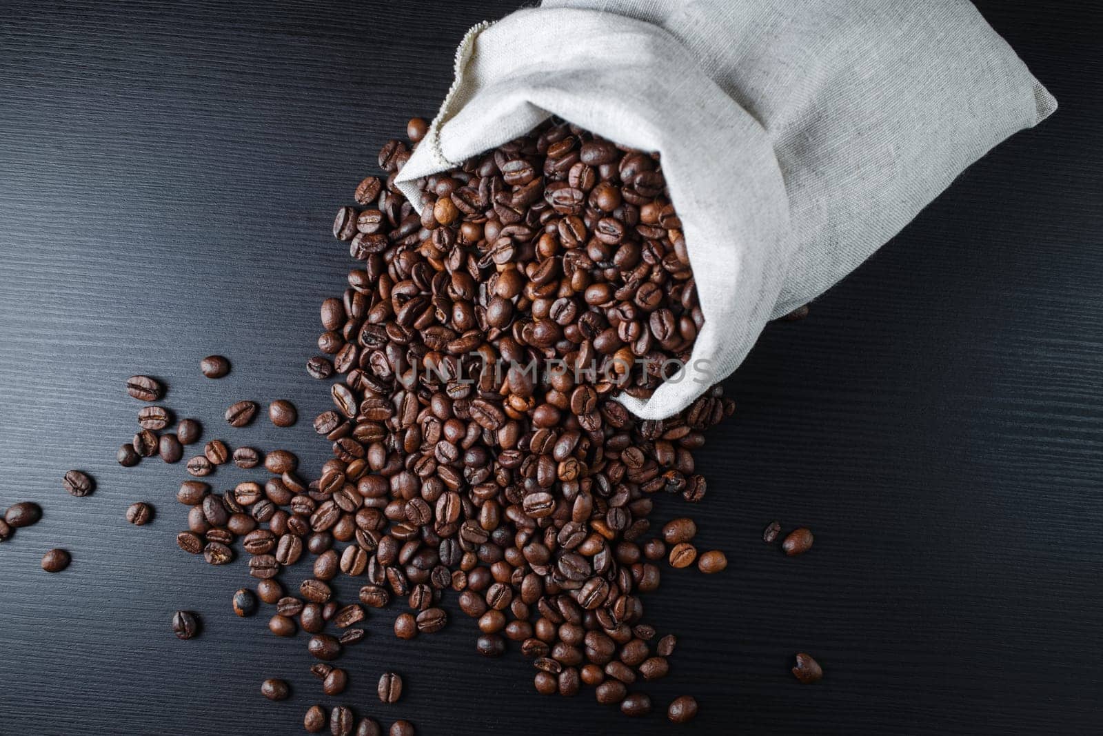 Roasted coffee beans and canvas bag. Top view.