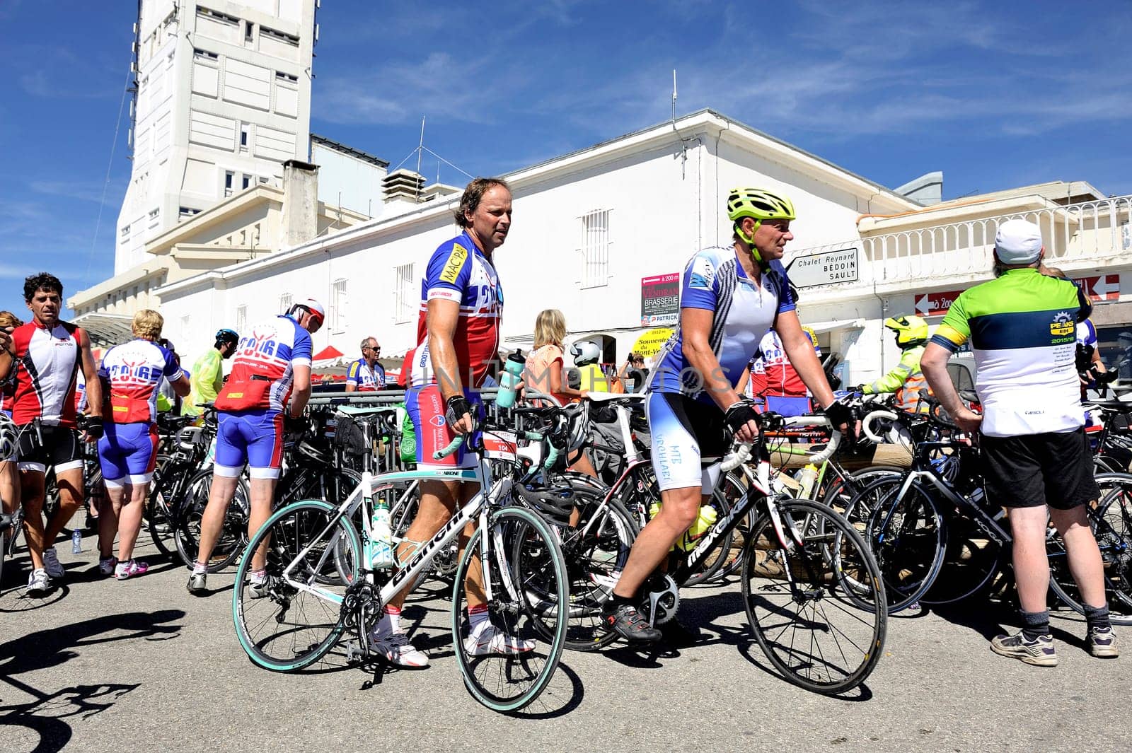 Numerous cyclists who climbed Mount Ventoux bike celebrate their performance atop proud of them and happy to be arrived
