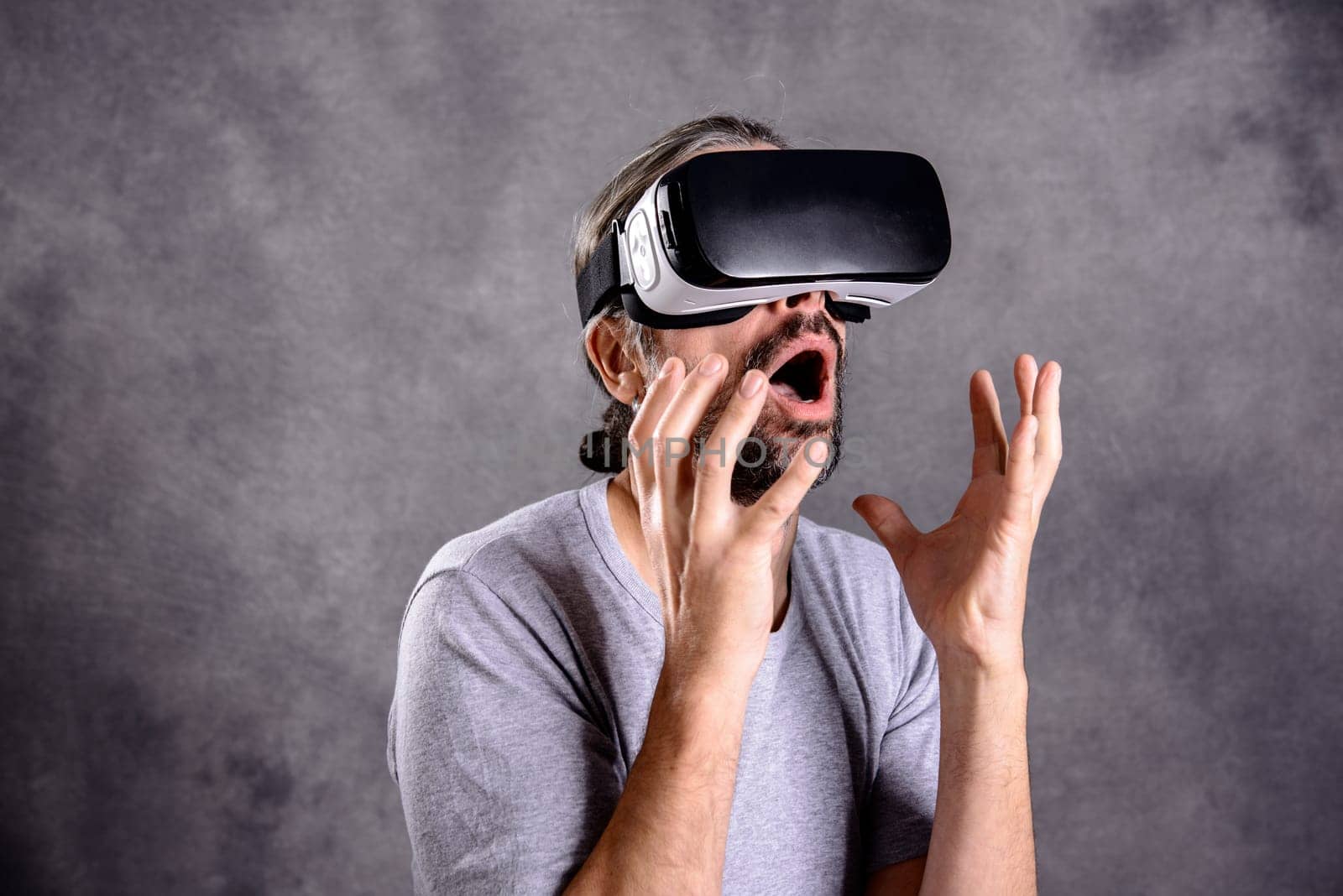 young man with virtual reality glasses looking surprised